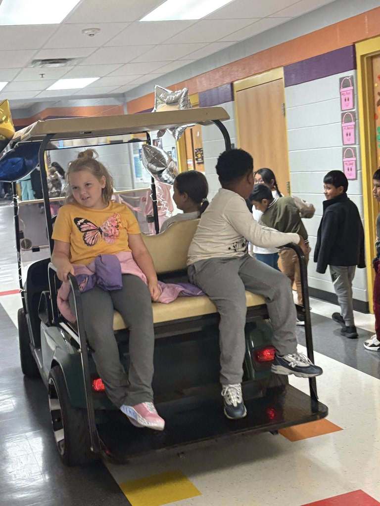 principals list riding a golf cart