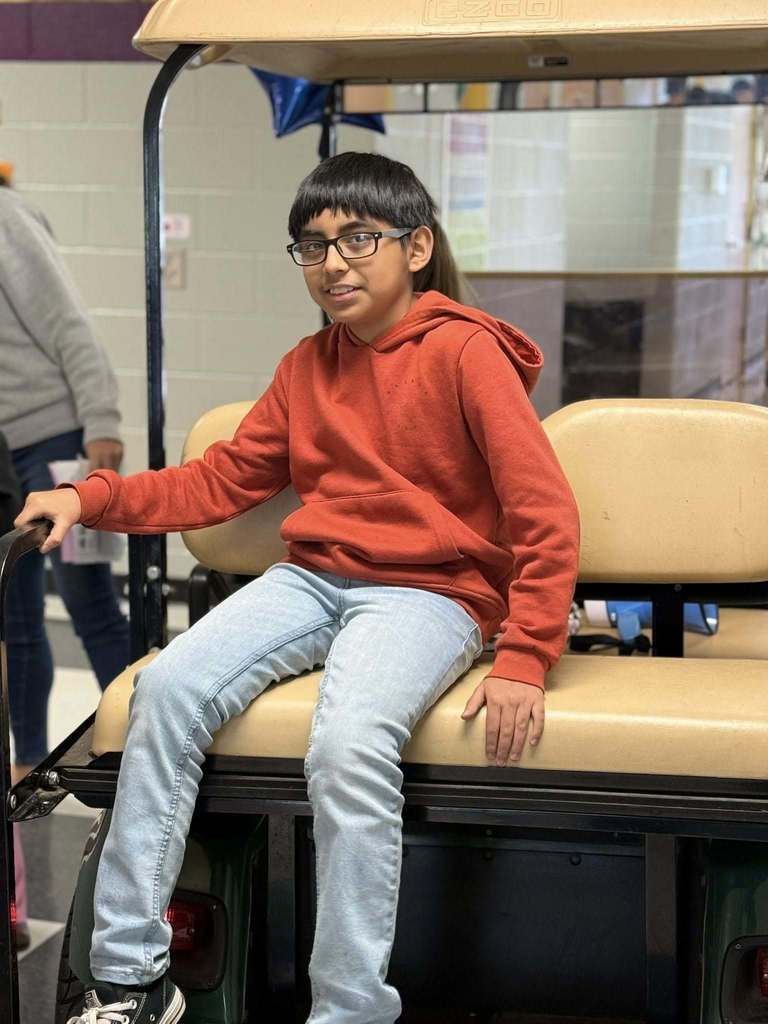 principals list riding a golf cart