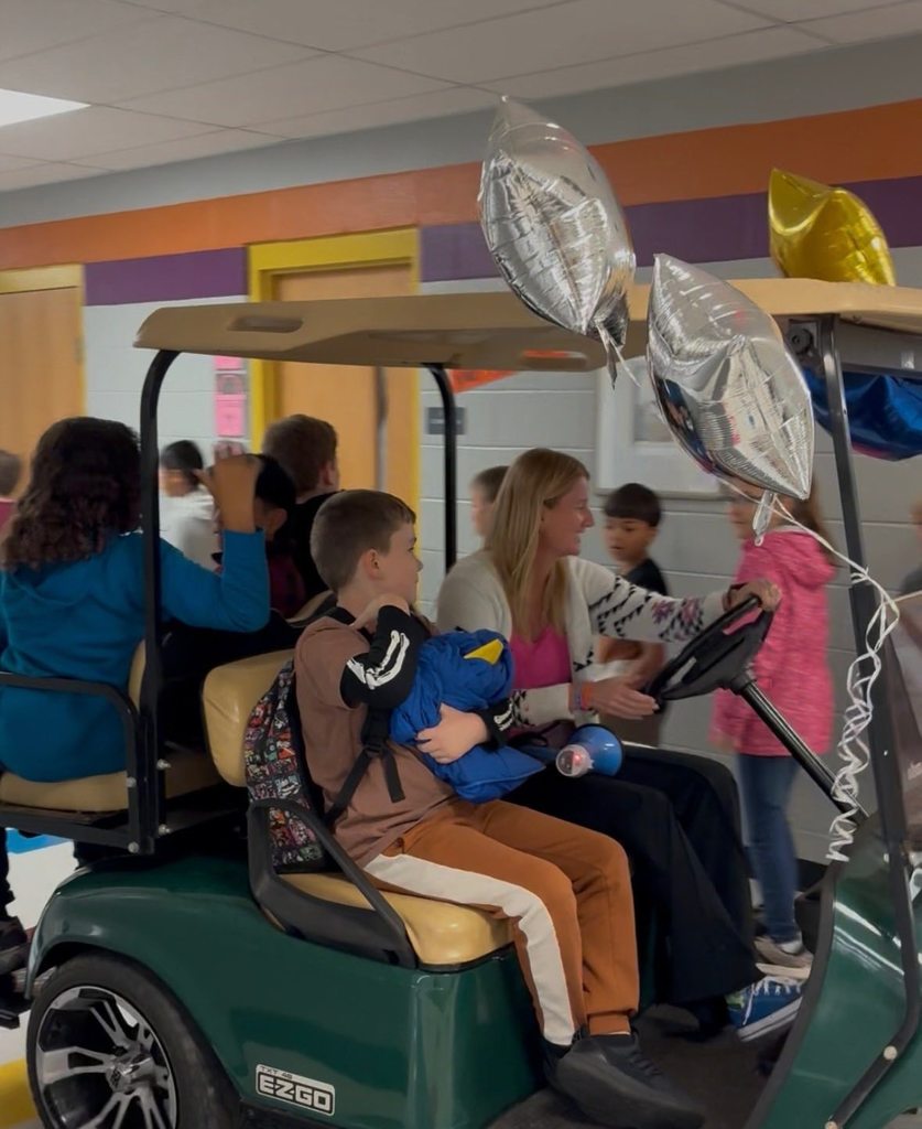 principals list riding a golf cart