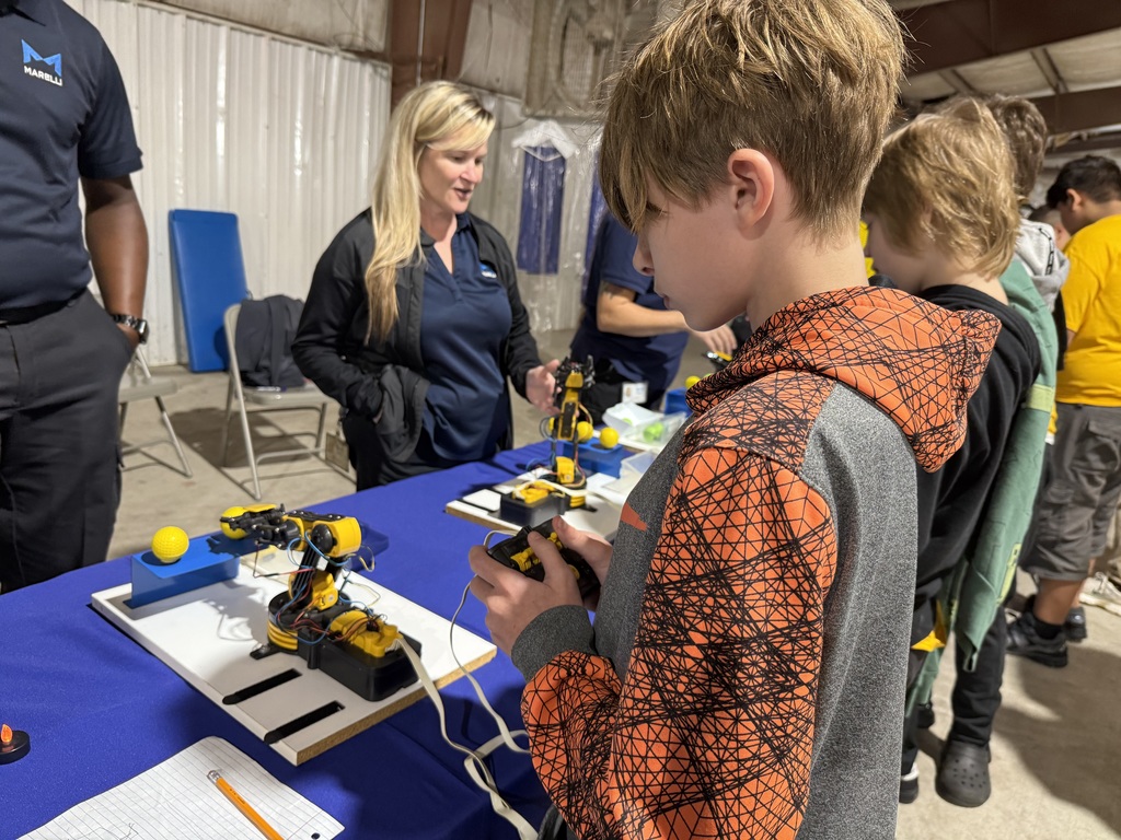 Student working with a robotic arm