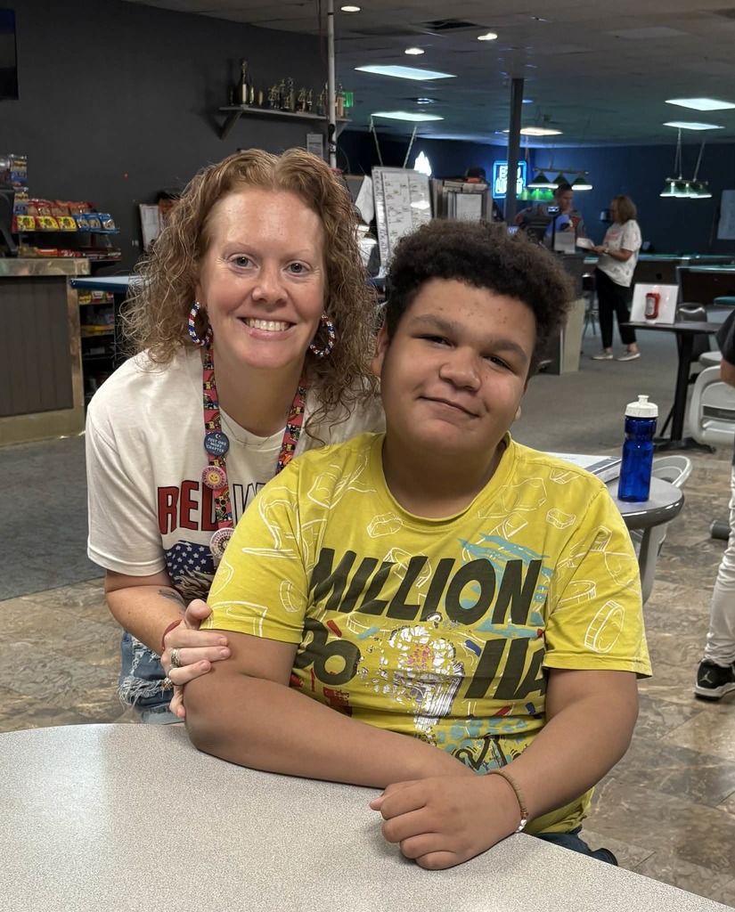 Student and teacher smiling on bowling trip