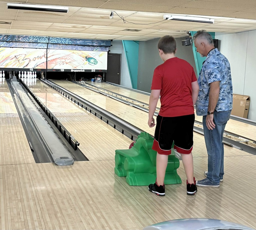 Mr. Paul teaching a student how to bowl