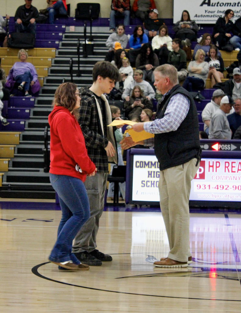 Seniors who were recently recognized at a basketball game for scoring 21 or higher on the ACT last year