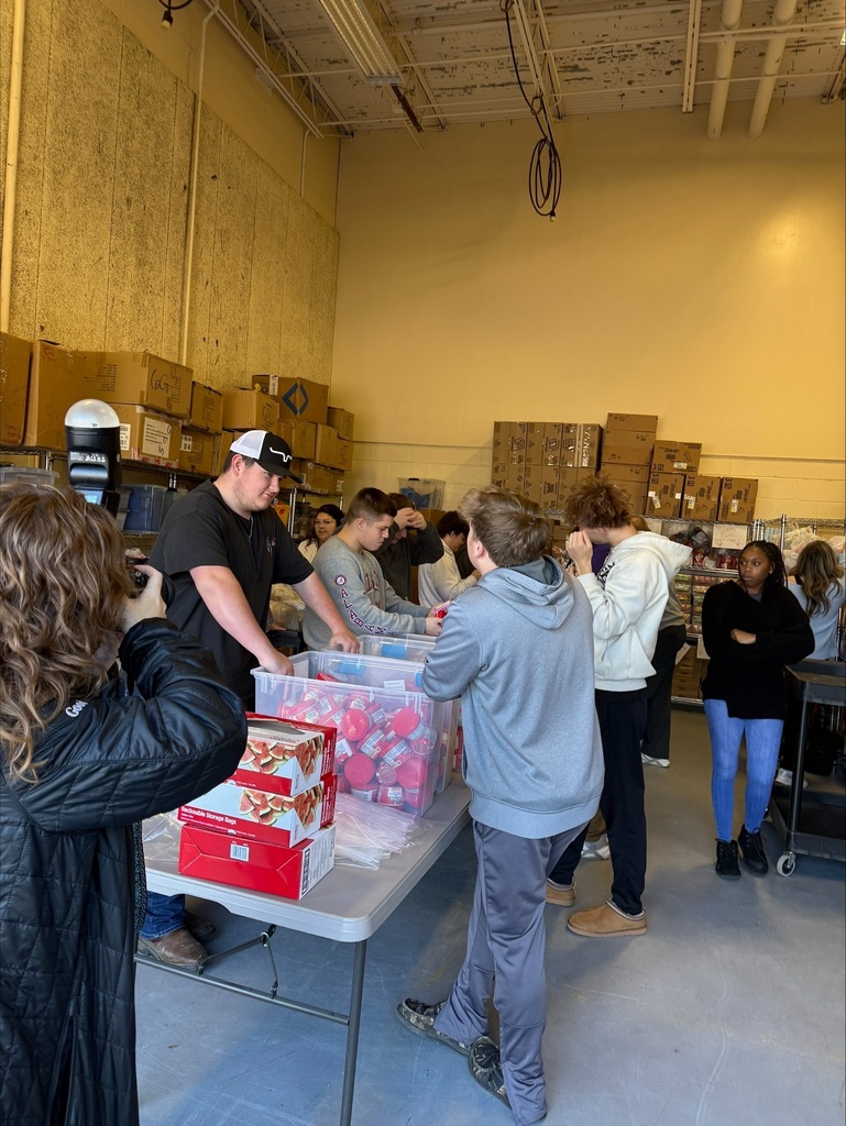 Community High School Football Team Volunteers to Pack Food for Backpack Program