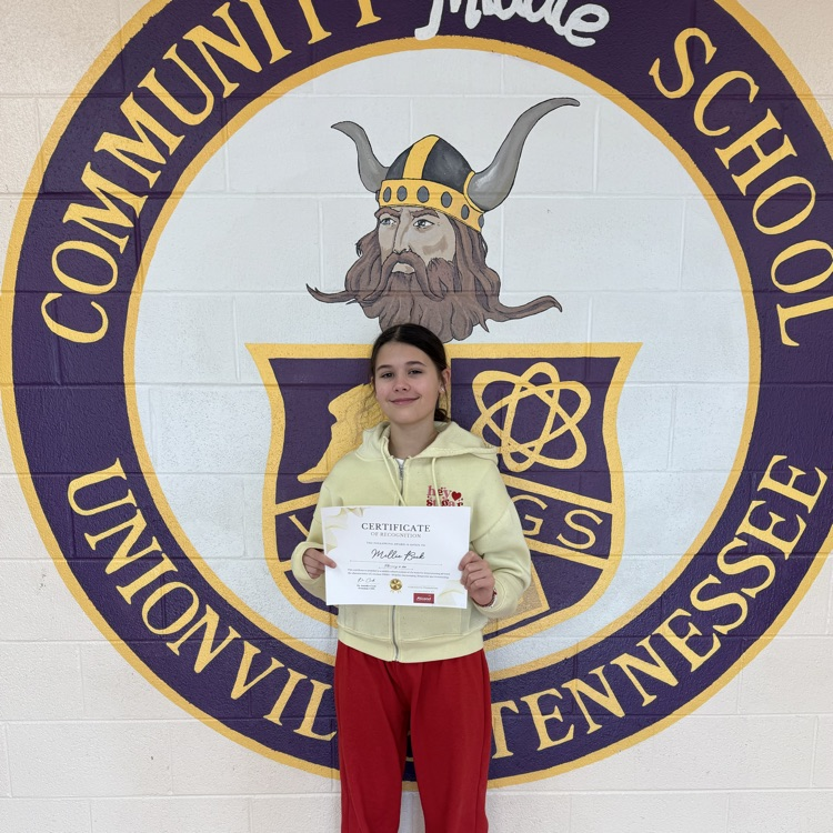 student smiling with certificate