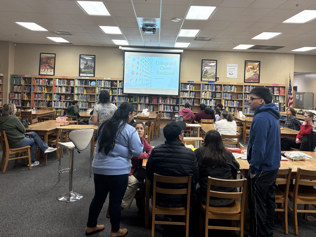 Parent University session in Harris Middle School's library with the Director of Career & Technical Education, Lori Sexton, giving a presentation.