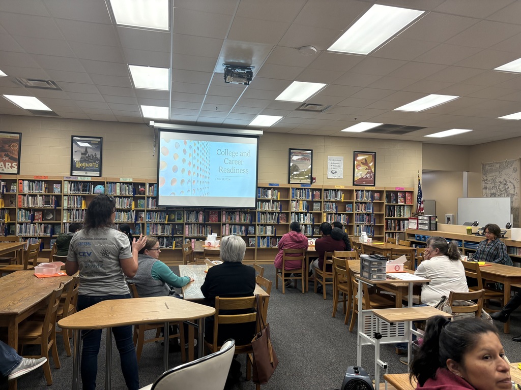 Parent University session in Harris Middle School's library with the Director of Career & Technical Education, Lori Sexton, giving a presentation.