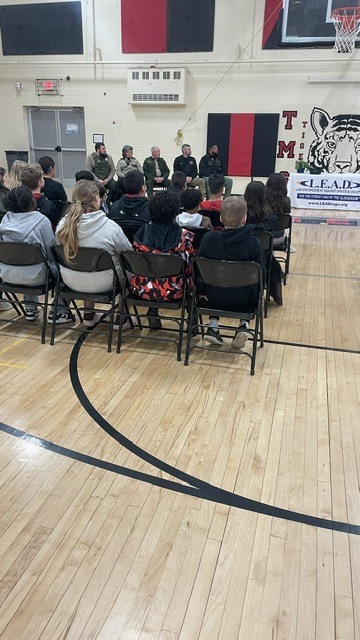 People are sitting in chairs participating in the L.E.A.D. program.