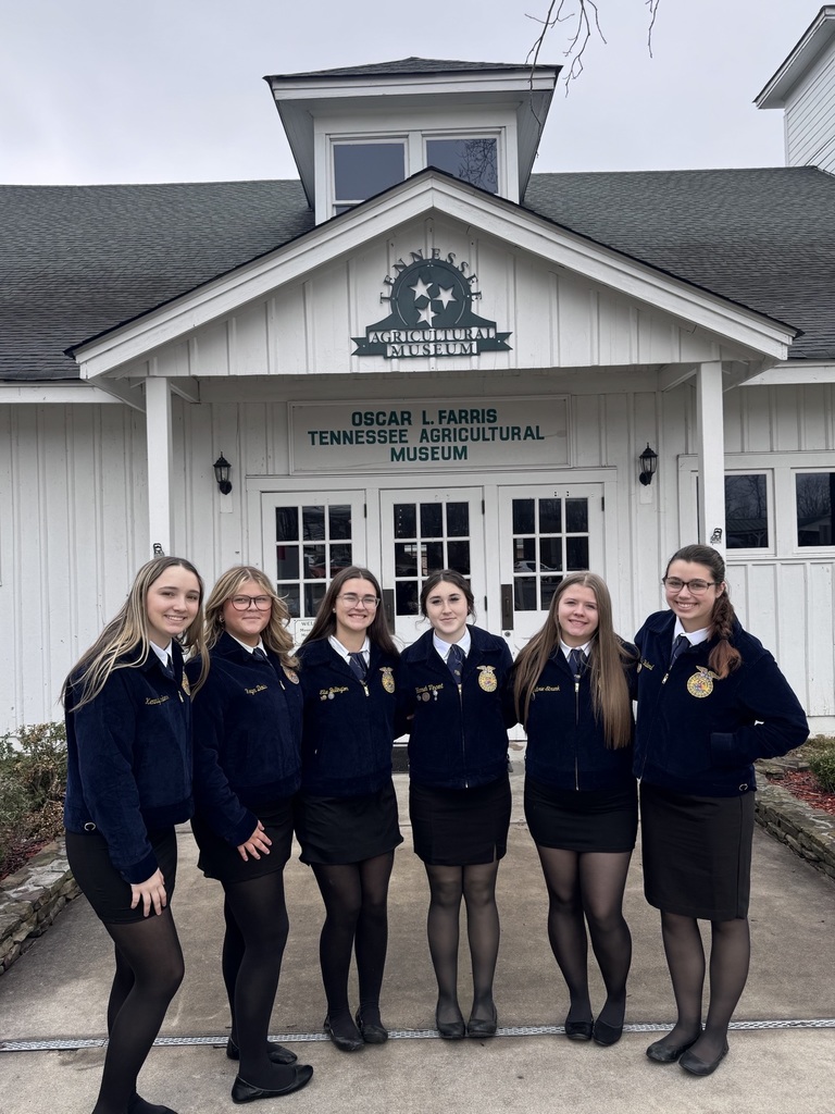 Community High School students pose outside in front of a museum for a group picture for FFA week.