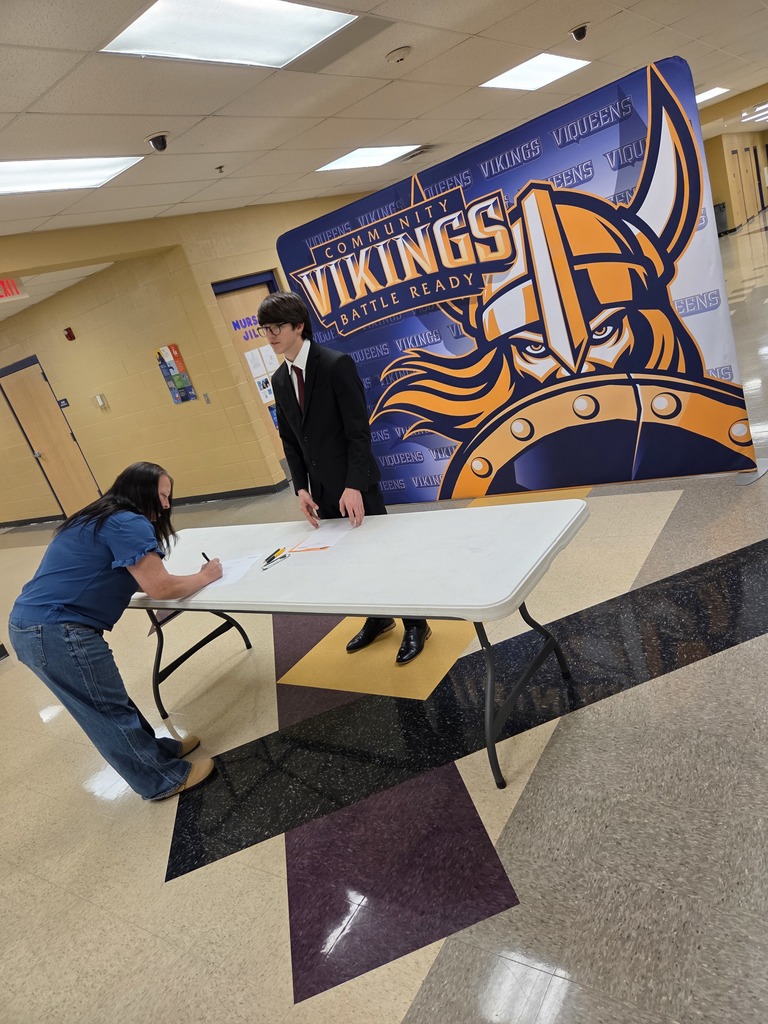 Student participating in HOSA Showcase with a community member