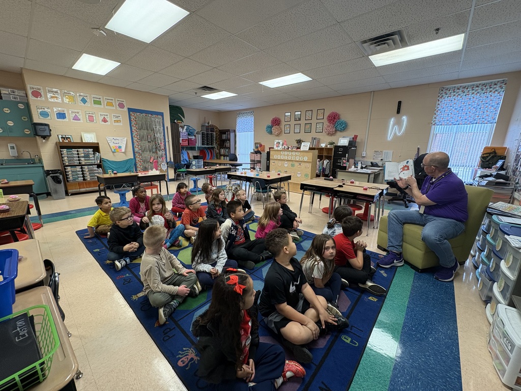 Volunteer reading to 1st grade class
