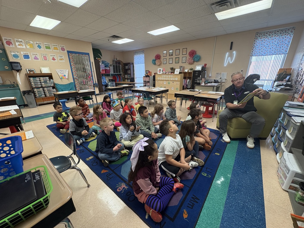 Volunteer reading to 1st grade class