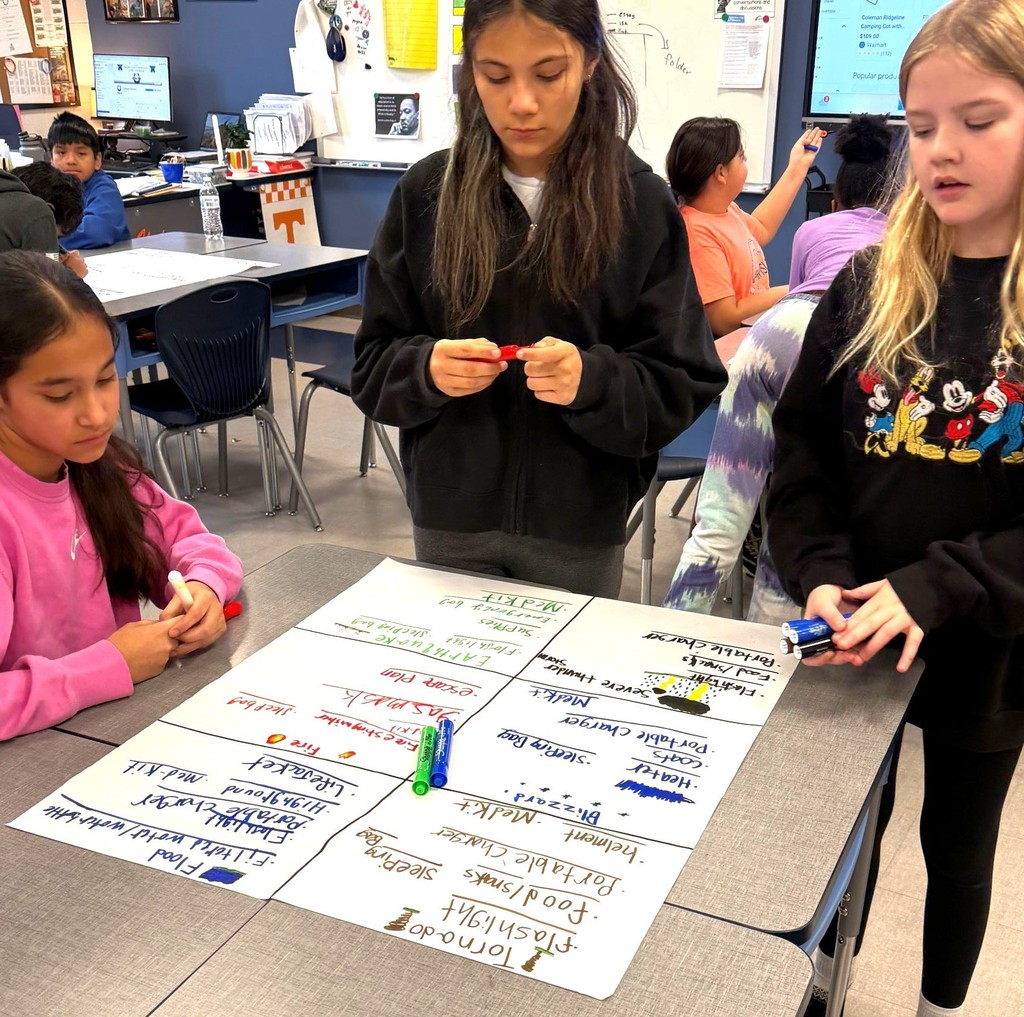 Cartwright Elementary students are brainstorming a STEAM project and writing it down on a poster board. 