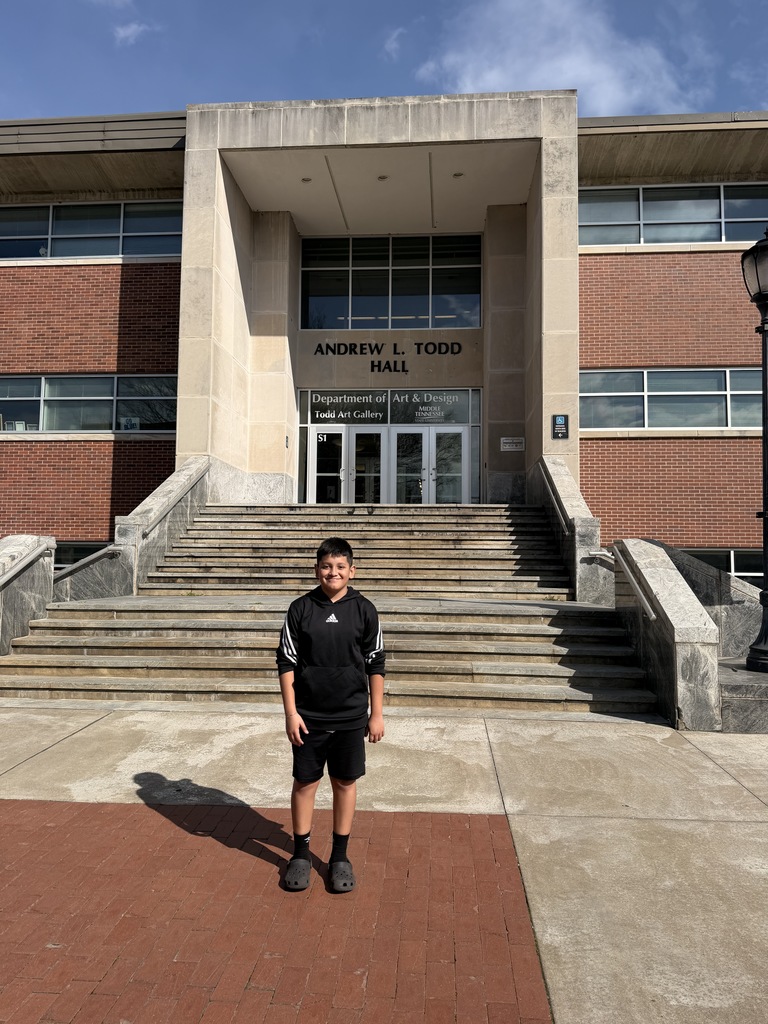 East Side Elementary School fifth grader poses for a picture in front of Andrew L. Todd Hall