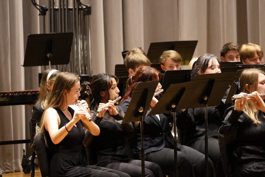 Students are playing their instruments. 