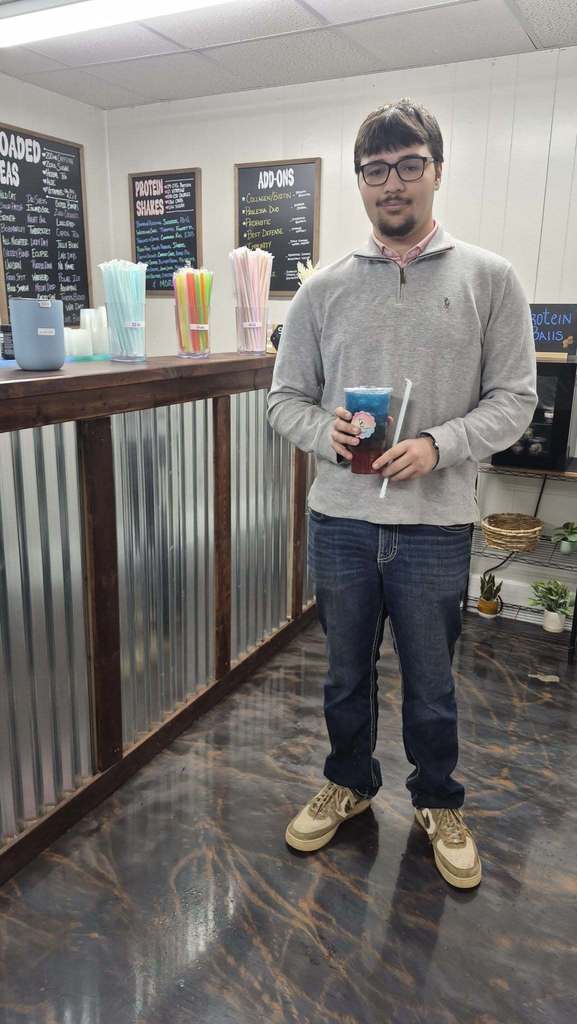 SCHS student is holding a drink from Celebration Nutrition for receiving CTE Marking Student of the Month.