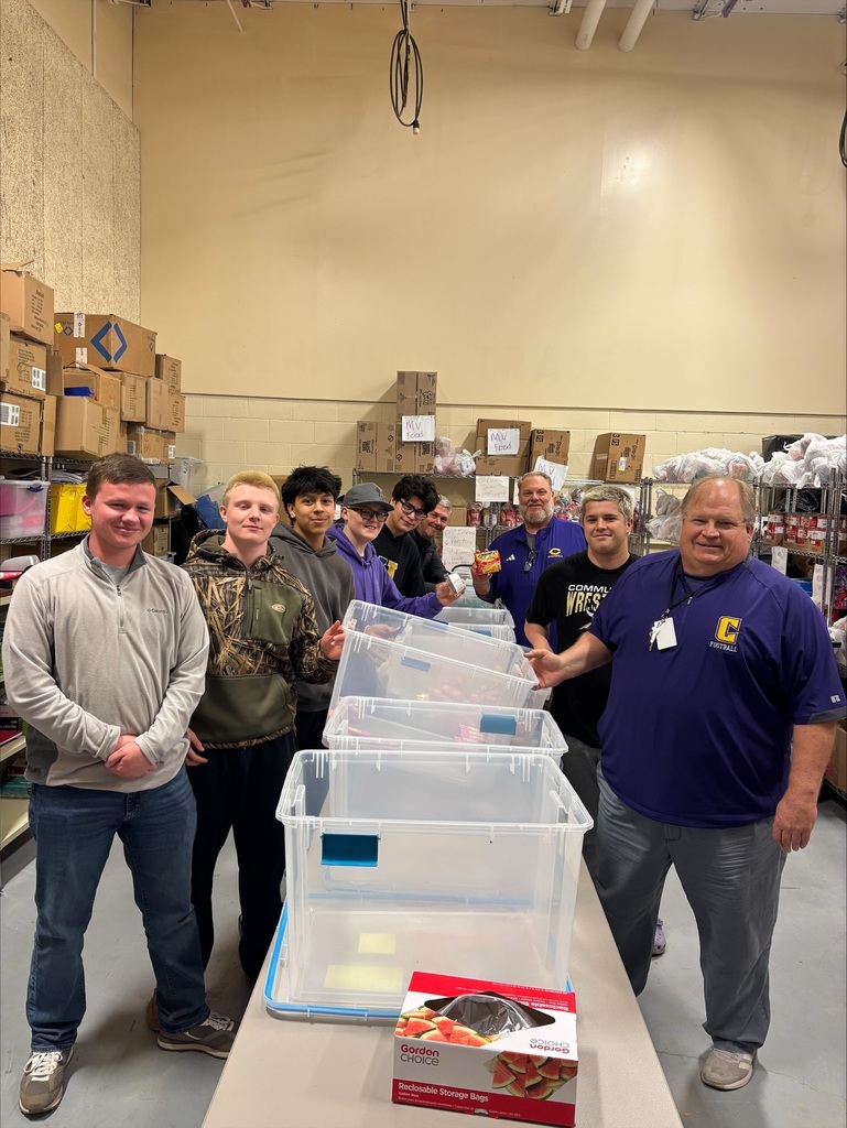 Community High School football players pack food bags for BCS backpack program. 