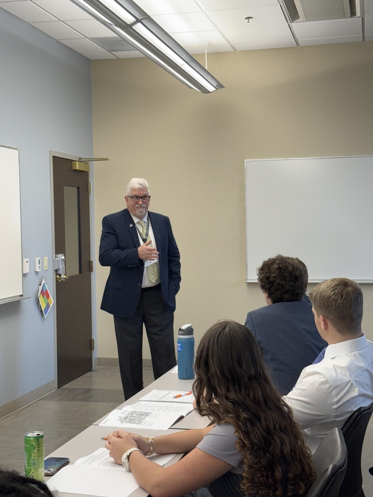 Picture of board member speaking to students at SCOPE event. 