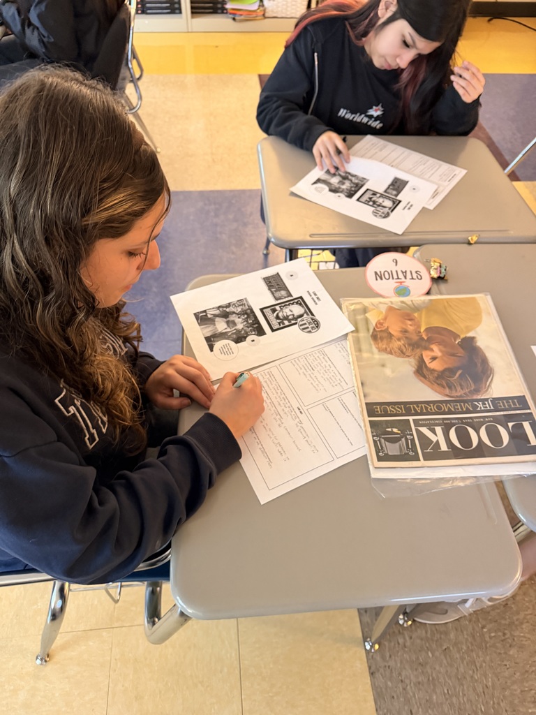 Students evaluate artifacts from the 1950s and 1960s.