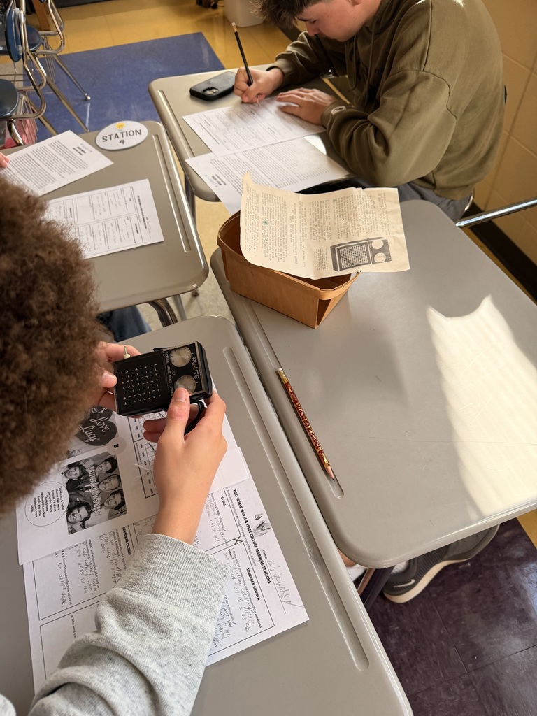 Students evaluate artifacts from the 1950s and 1960s.