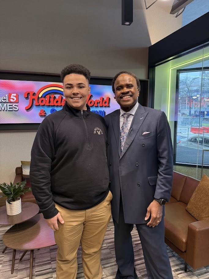 Student poses for a picture with Senior Meterologist Lelan Statom. 