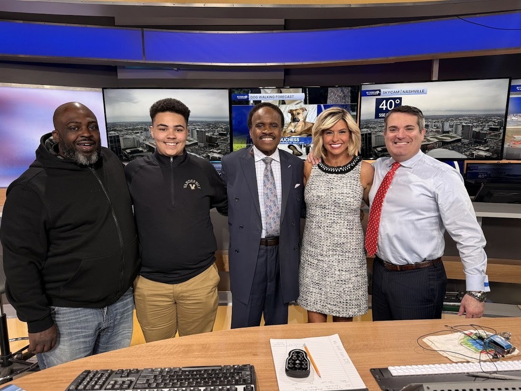 Group photo of student and parent along with members of the News Channel 5 weather team. 