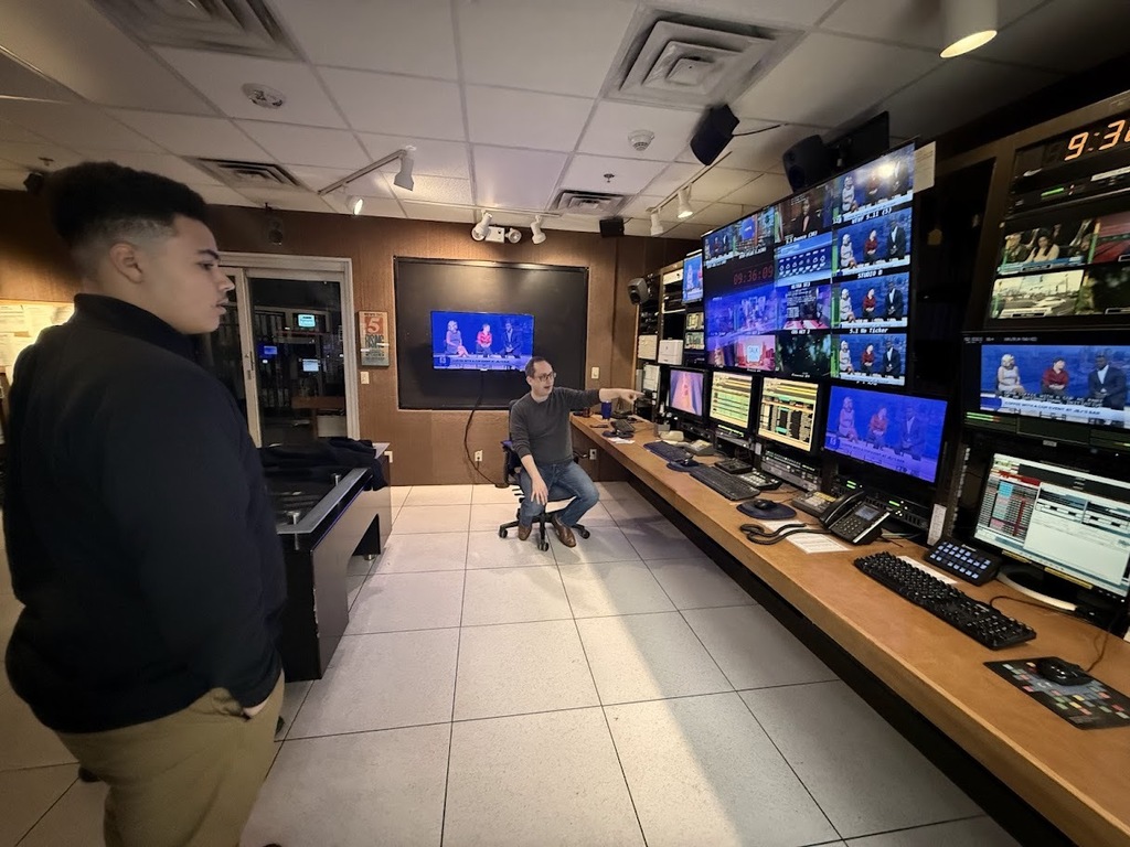 Student watches live broadcasts from mulitple screens.