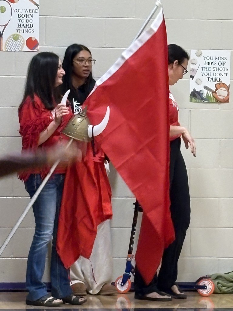 Teachers holding Viking hat and red flag