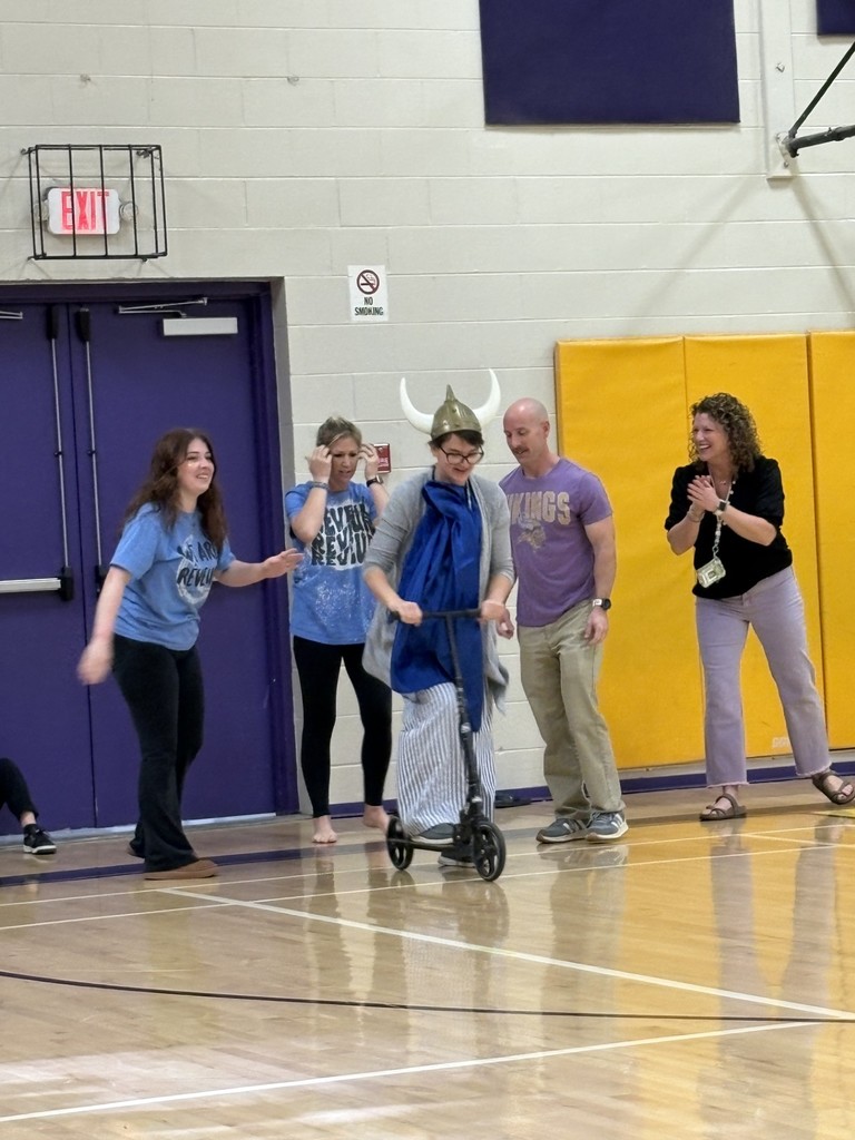 Teacher dressed like a Viking on a scooter