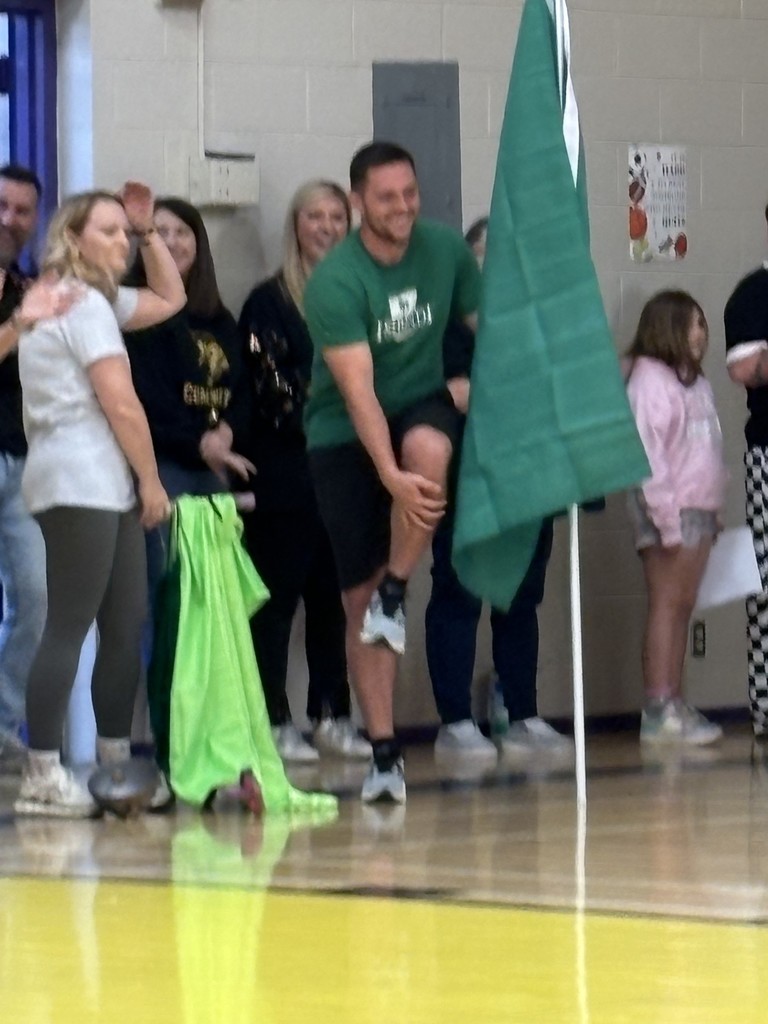 Teacher holding green house flag