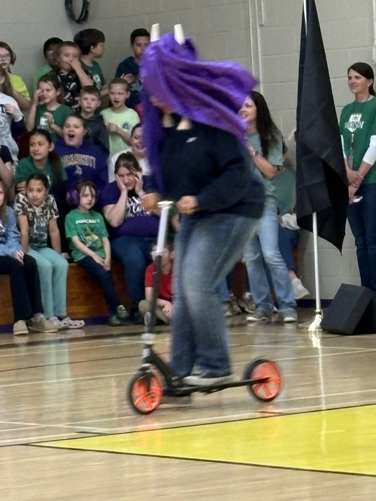 Teacher dressed like a Viking on a scooter