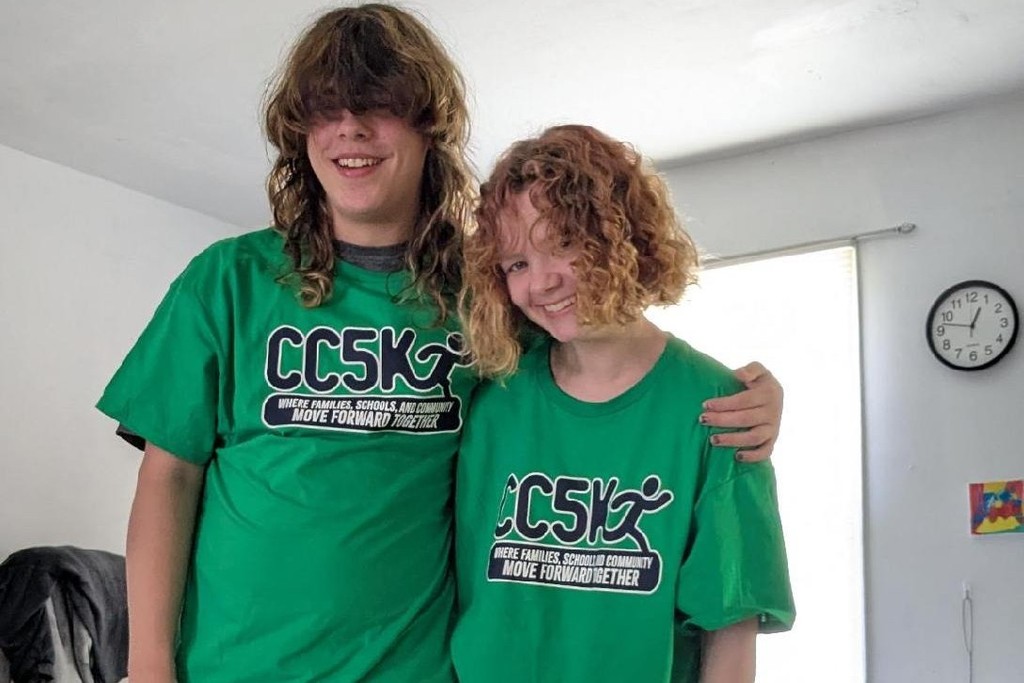 Two people are wearing their CC5K shirts. 