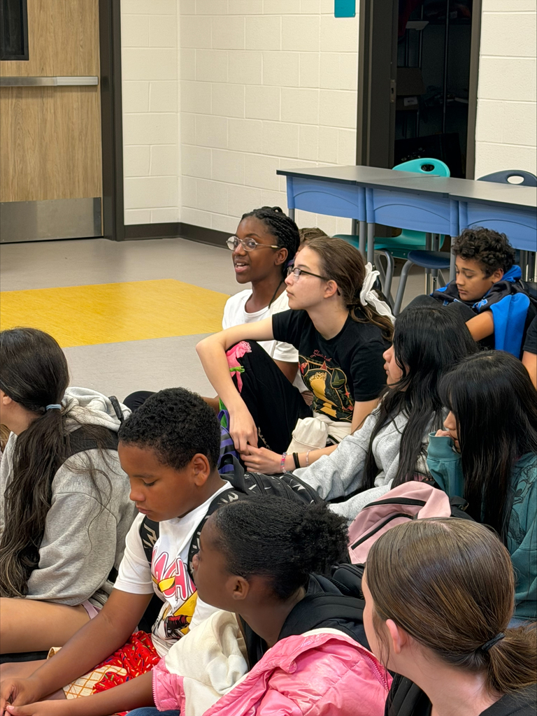 Group of students sitting on the floor.