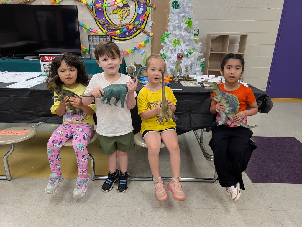 Pre-K kiddos holding toy dinosaurs