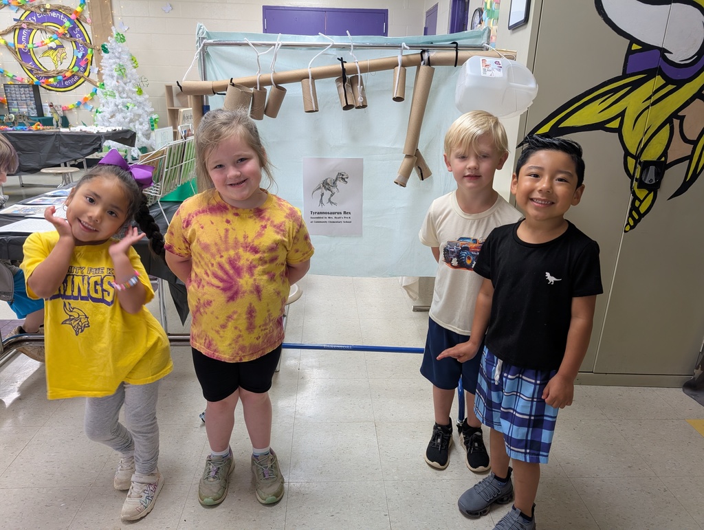 Pre-K kiddos standing in front of handmade dinosaur 