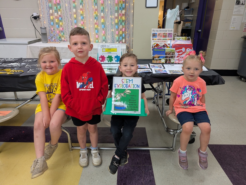 Pre-K kiddos in front of dinosaur crafts