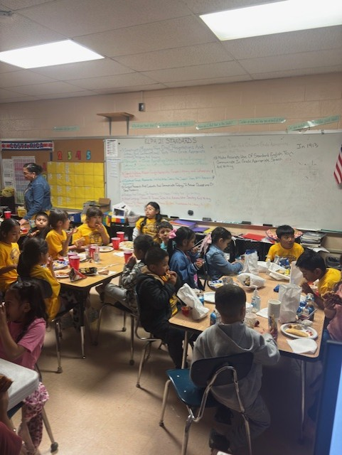 Students enjoying food from families and sponsors