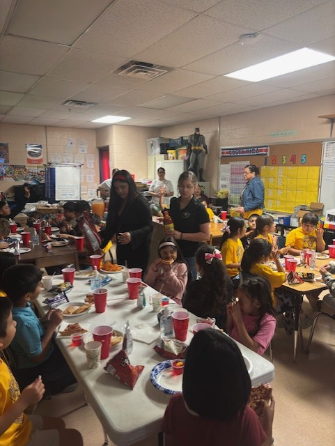 Students enjoying food from families and sponsors