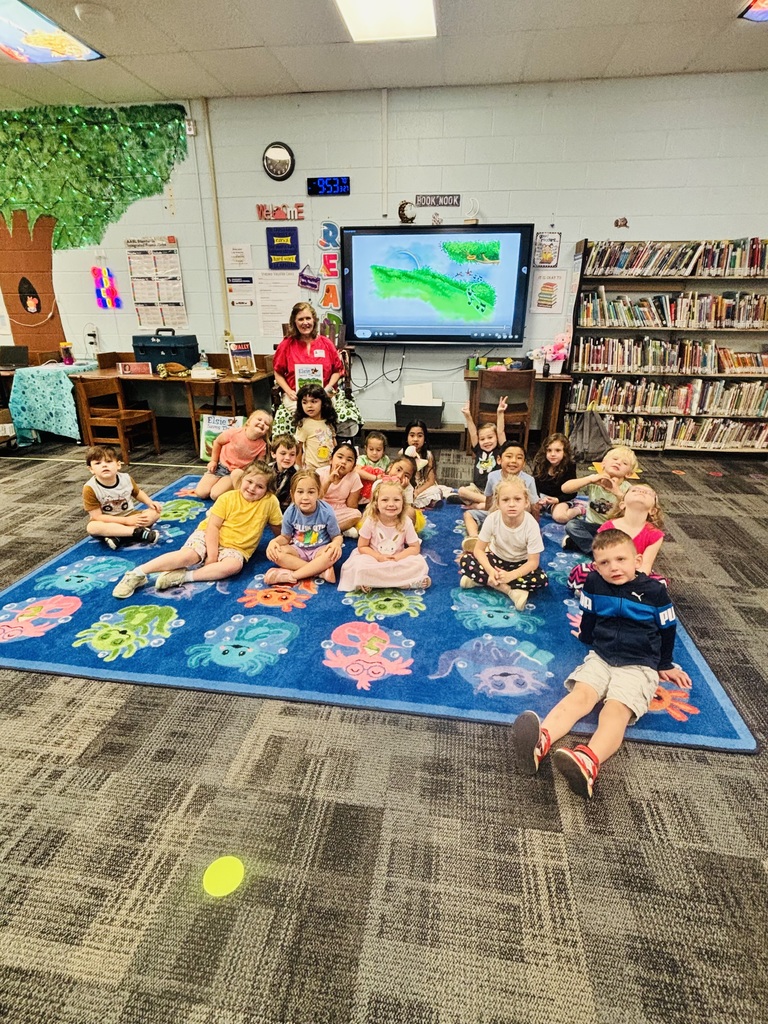Author visit, students looking at camera in front of author