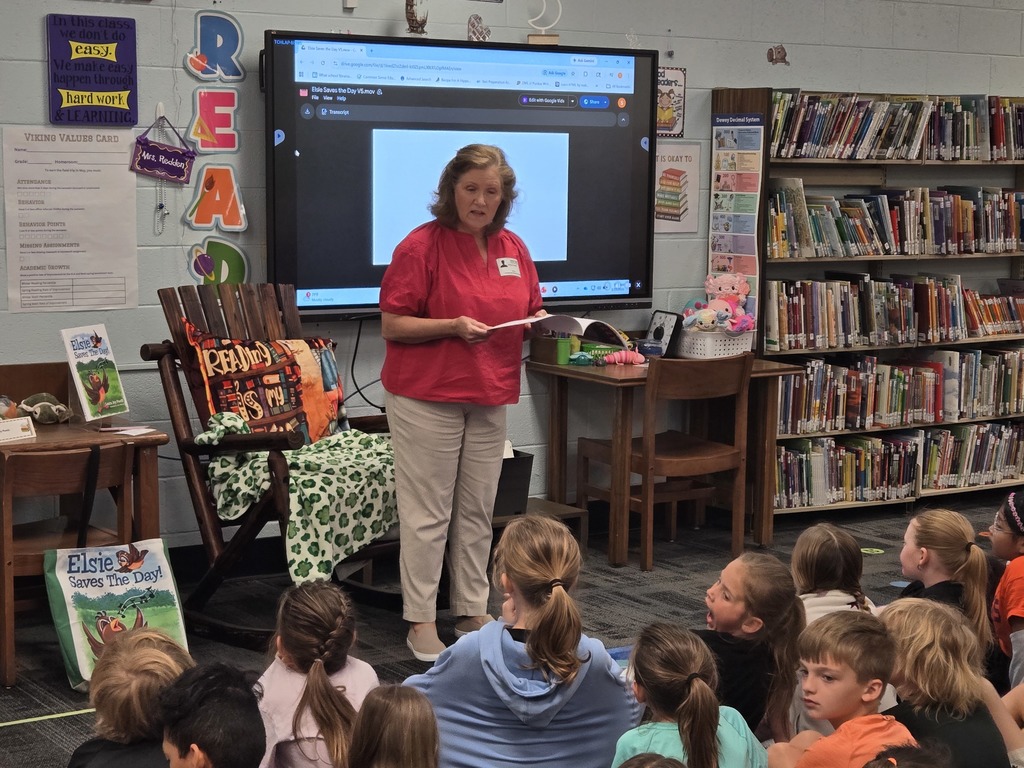 Author visit, students listening and looking at Author