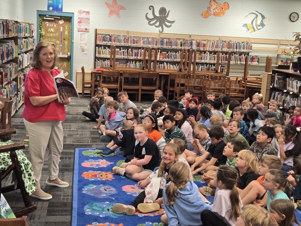 Author visit, students listening and looking at Author