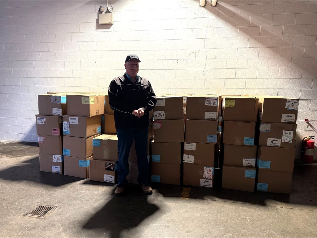Person standing in front of food boxes that were packed for spring break.