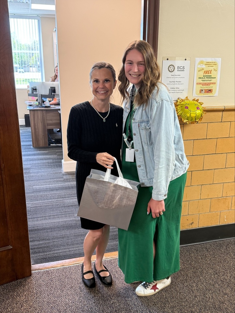Group picture of people standing in the hallway.
