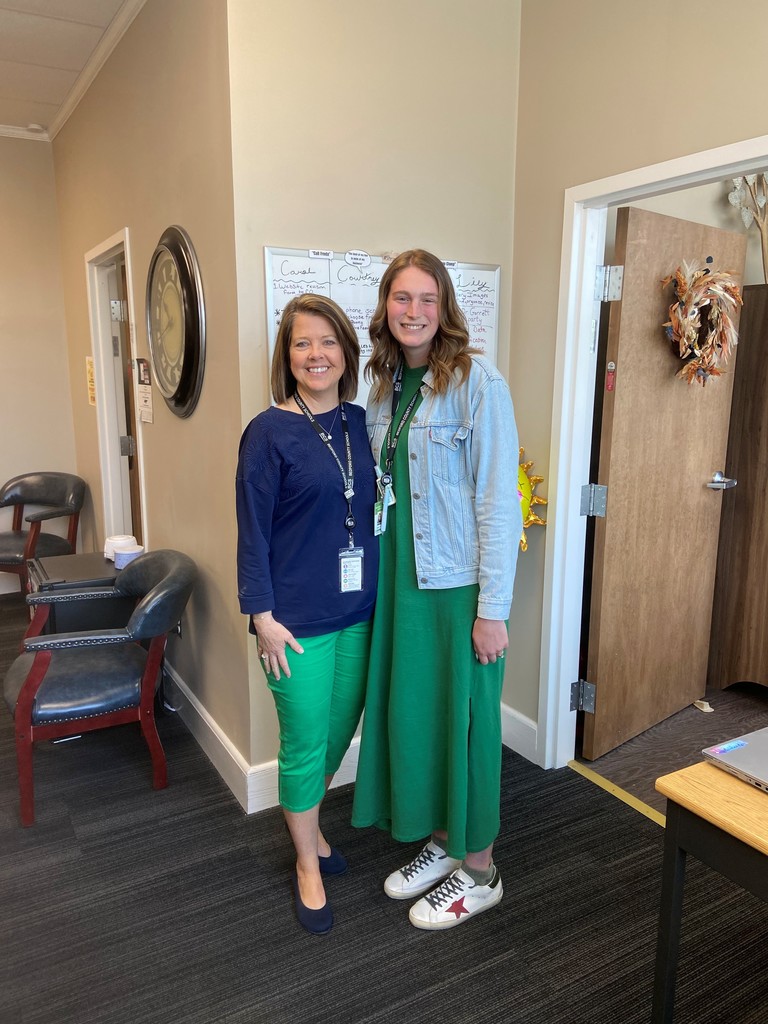 Group picture of people standing in an office.