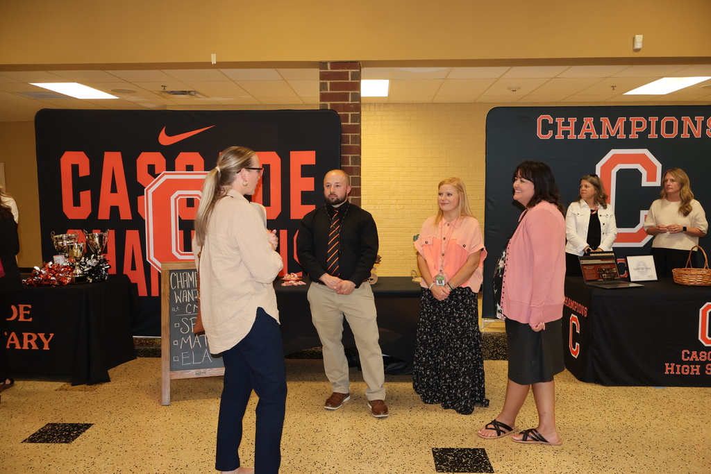 Administrators speaking with person at Teacher Recruitment Fair.