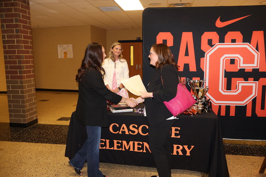 Principal and Visitor Shaking Hands at the Teacher Recruitment Fair 