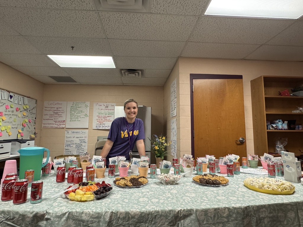 smiling woman with table full of food and drinks