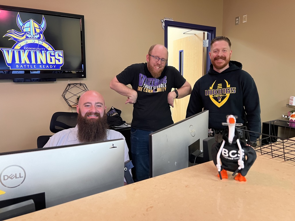 Staff from Community High School pose with Bart the porch goose.