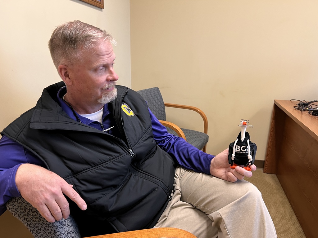 Dr. Ralston holds Barthalemew G. Honksworth in his hand.
