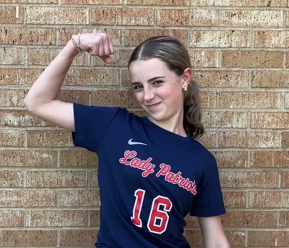 Liberty School student flexes her arm muscle to show school spirit about the CC5K.